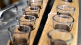 A close-up of cupping therapy cups arranged on a wooden table.