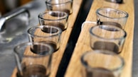 Single-serving glass cups arranged neatly on a wooden tray, perfect for intimate gatherings.