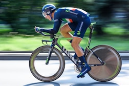 A professional cyclist racing on a scenic route, embodying speed.