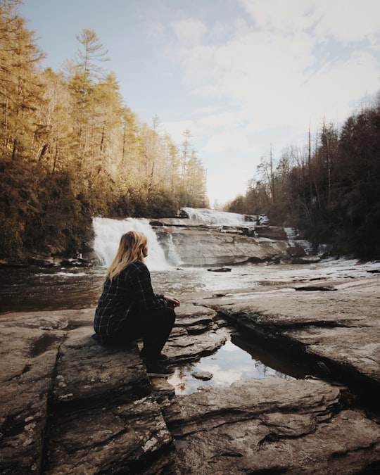 woman sitting near falls in Triple Falls United States