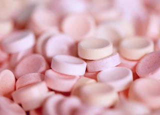 tilt-shift photography of pink medicine tablet lot