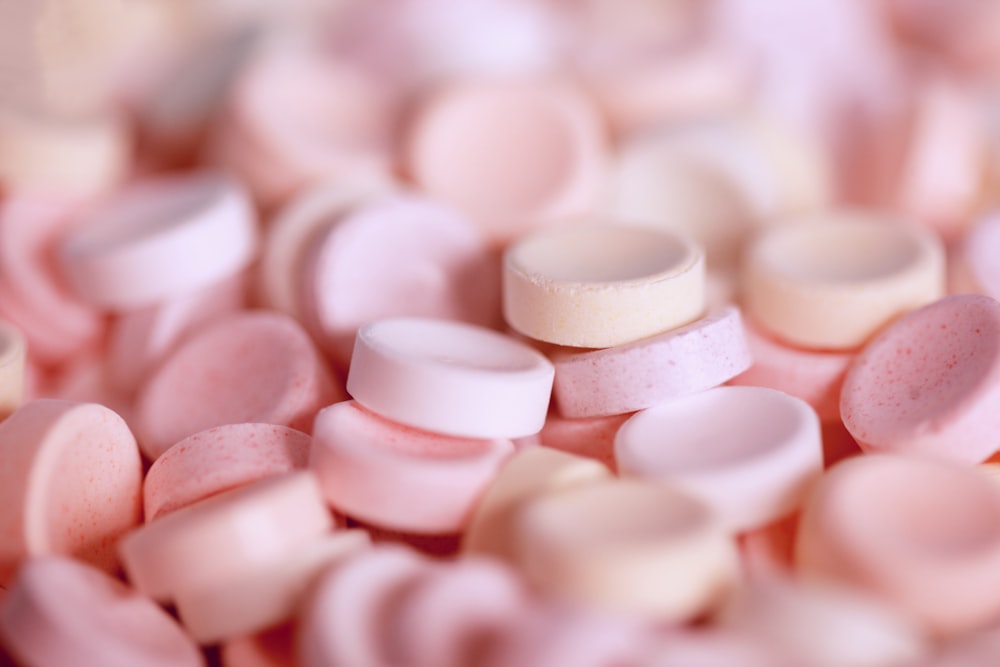 tilt-shift photography of pink medicine tablet lot