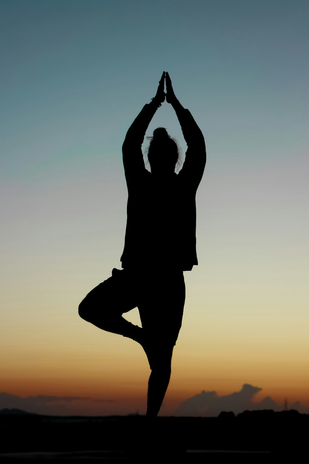 silhouette of person performing yoga