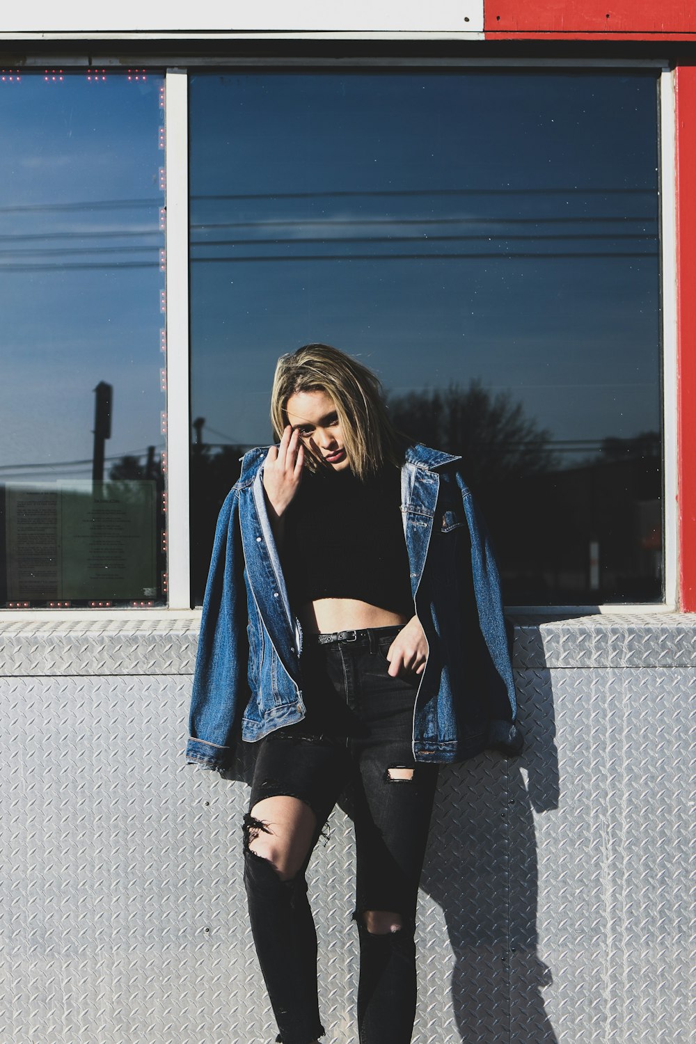 woman leaning on stainless steel bench