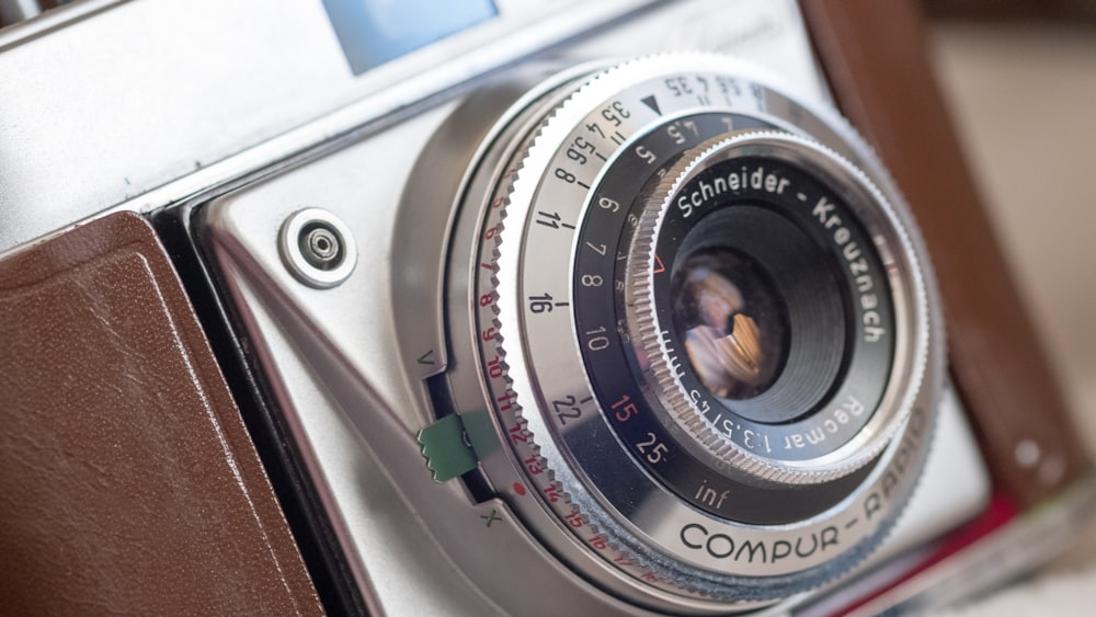 macro shot photograph of silver and black SLR camera