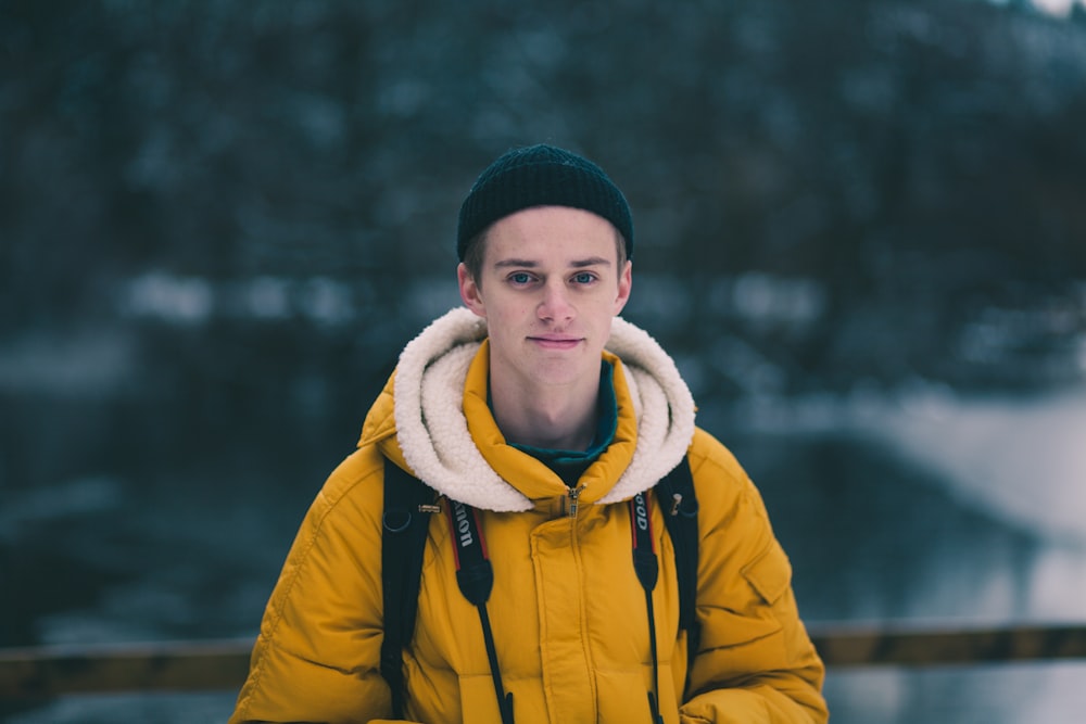 selective focus photograph of man in yellow jacket