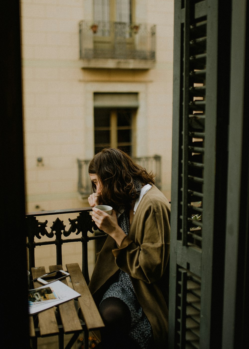 woman drinking white sitting on bench