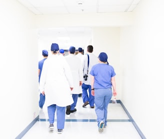 group of doctors walking on hospital hallway