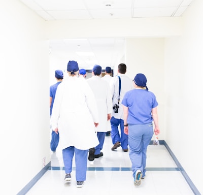 group of doctors walking on hospital hallway