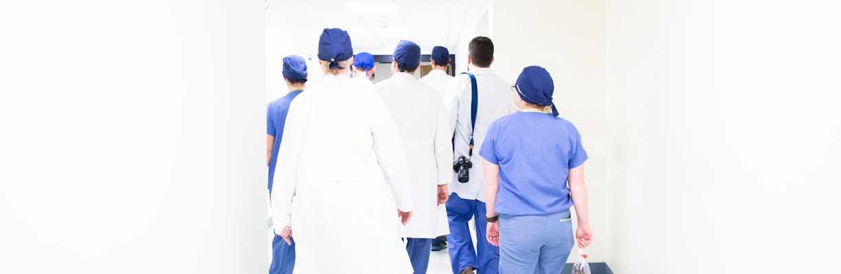 group of doctors walking on hospital hallway