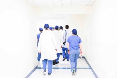 group of doctors walking on hospital hallway