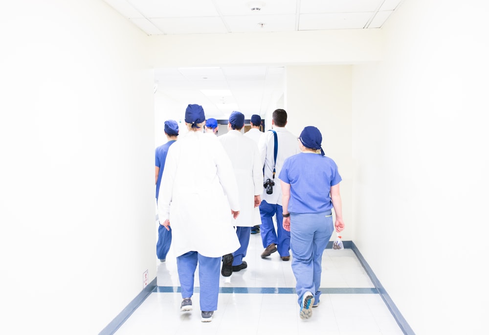 group of doctors walking on hospital hallway