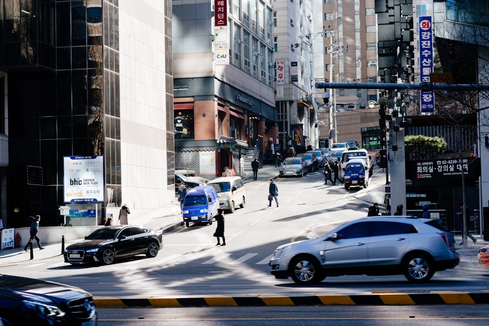 photo of cars and people on road