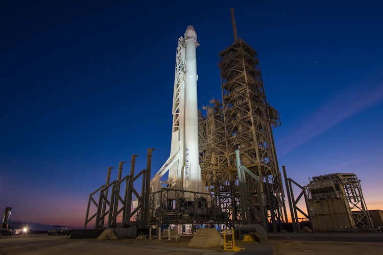 Rocket launch at night with bright exhaust plume