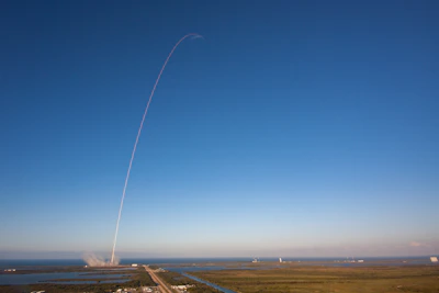 Close-up of a SpaceX rocket launching into a clear blue sky.