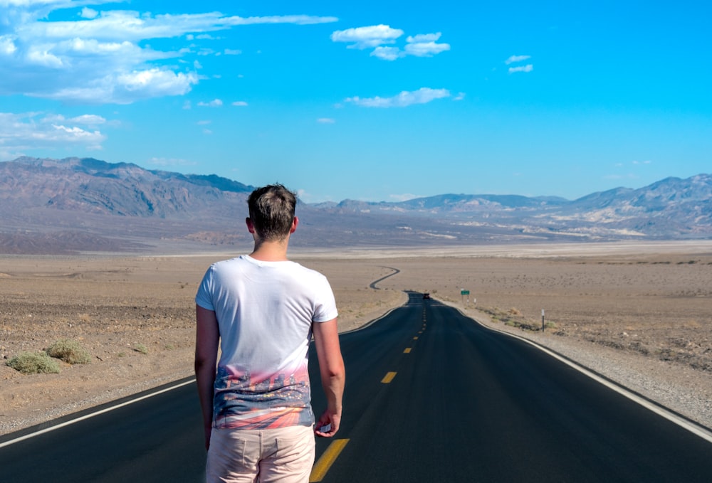 man standing in the middle of the road