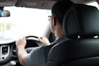 man driving car during daytime