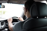 man driving car during daytime