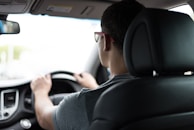 man driving car during daytime