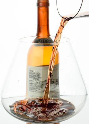 Close-up of rich, amber liquid being poured into a glass.