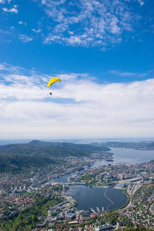 person paragliding over city in Bergen Norway