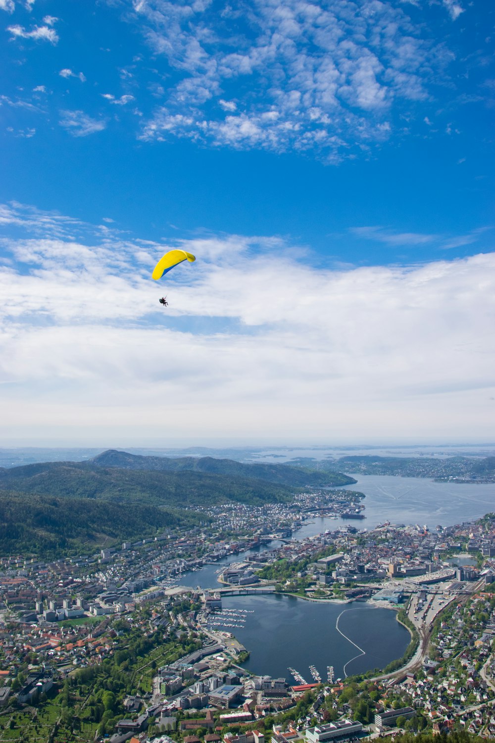 person paragliding over city