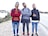 A diverse group of young adults wearing casual streetwear, walking confidently in an urban setting.