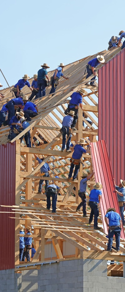 people building structure during daytime