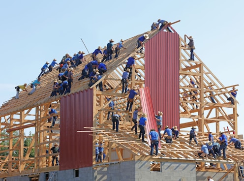 people building structure during daytime