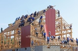 people building structure during daytime