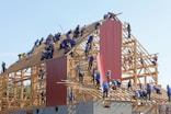 people building structure during daytime