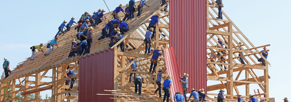 people building structure during daytime