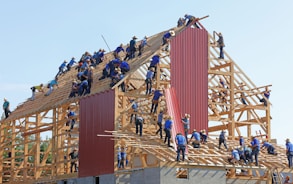 people building structure during daytime