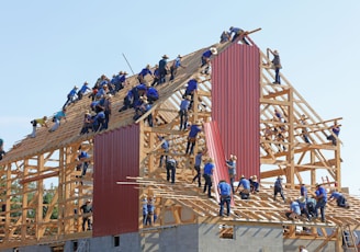 people building structure during daytime