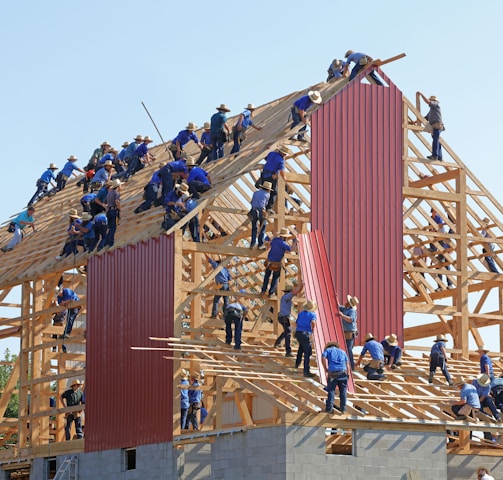 people building structure during daytime