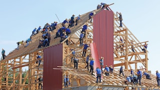 people building structure during daytime