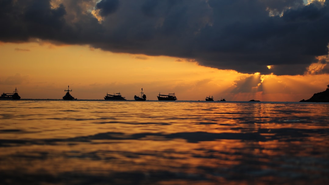 landscape photography of group of ships under golden hour,