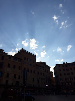 Sunlight falling on the historic architecture of a charming Spanish town square.