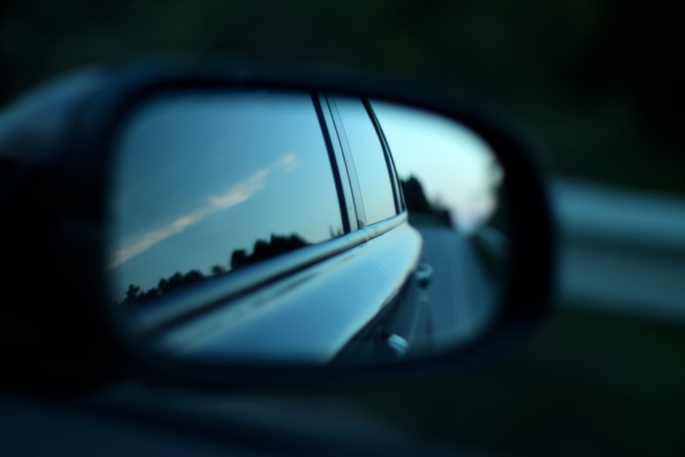 black car through wing mirror