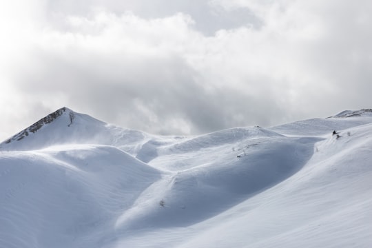 white snow mountain under cloudy sky in Rolle Pass Italy