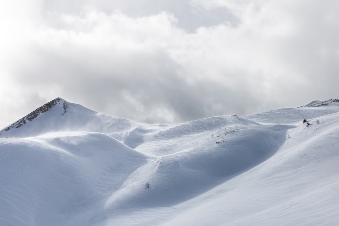 white snow mountain under cloudy sky, After a long hike and an unexpected blizzard I saw this spectacular landscape.