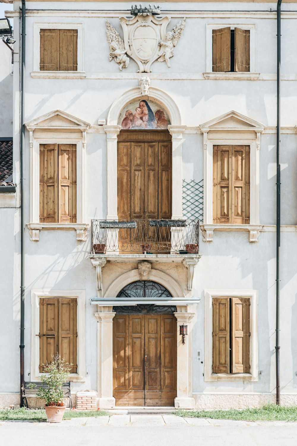 white concrete building with wooden doors and windows