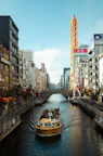 yellow boat in canal between buildings during daytime