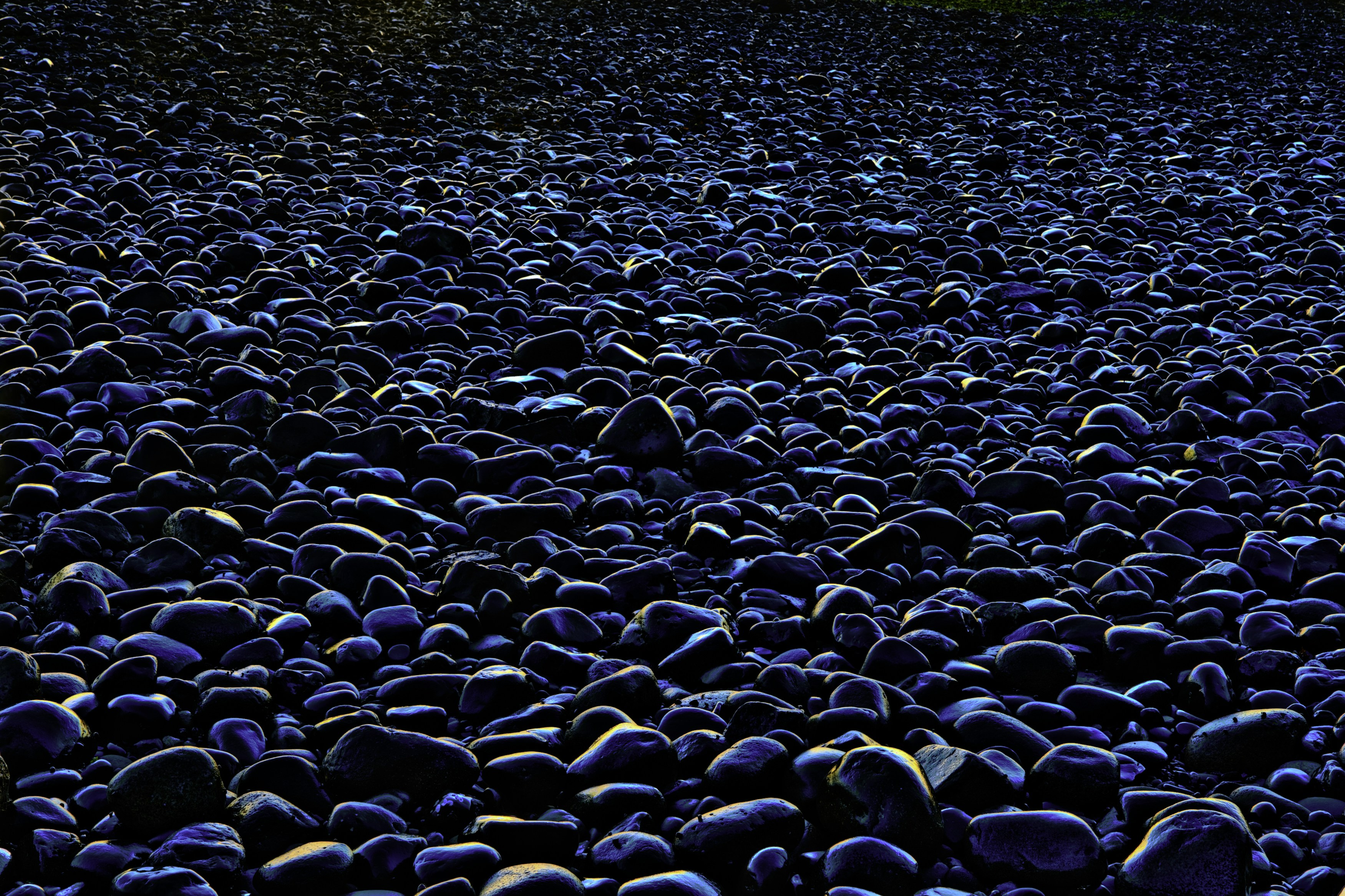 closeup photo of black and blue pebbles