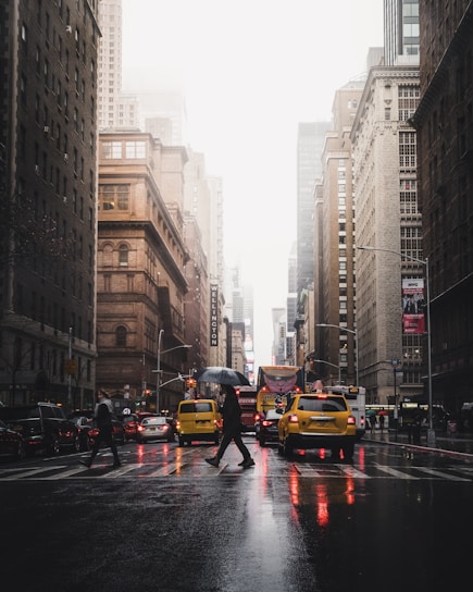 person walking on pedestrian lane between buildings