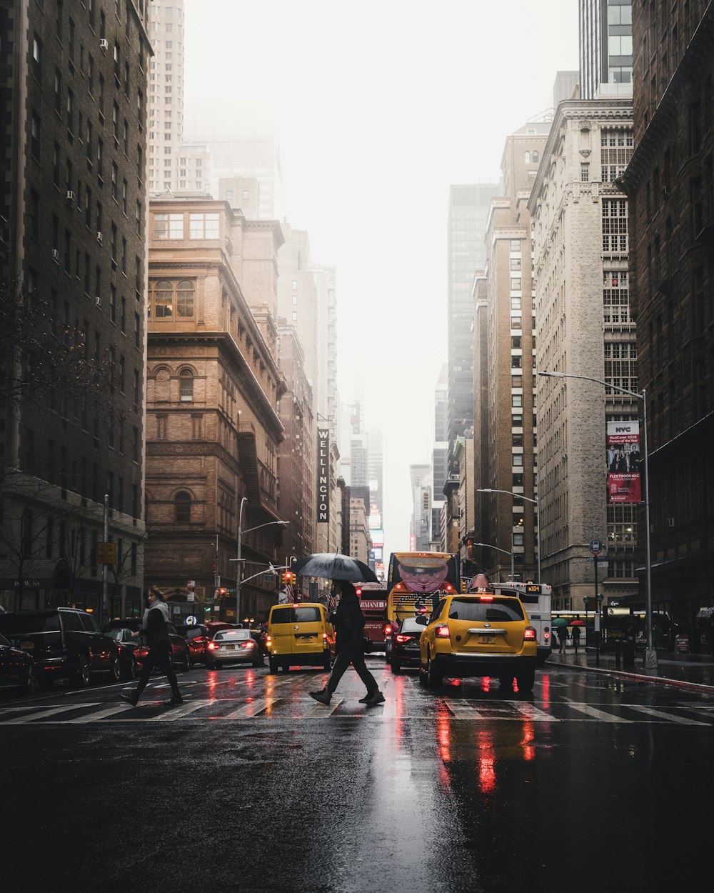 person walking on pedestrian lane between buildings