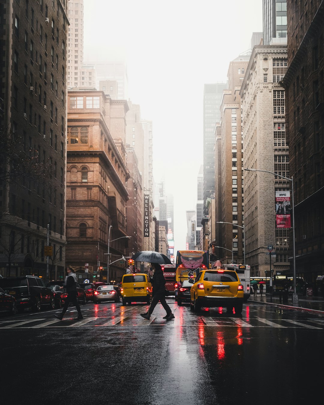 person walking on pedestrian lane between buildings