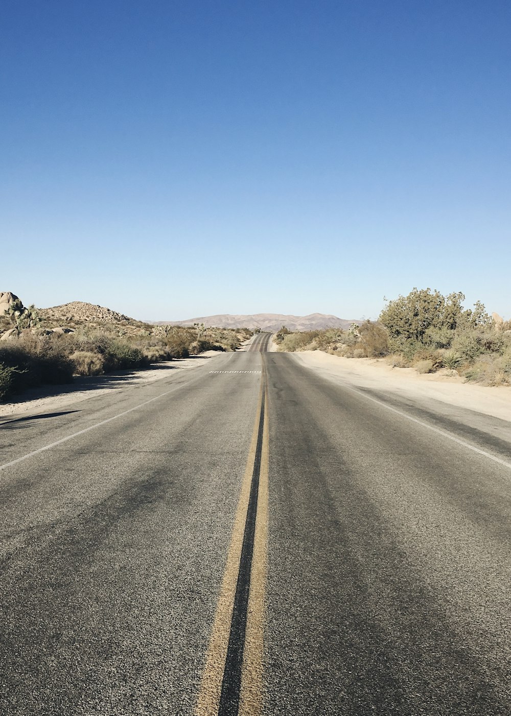 gray asphalt road pathway during daytime