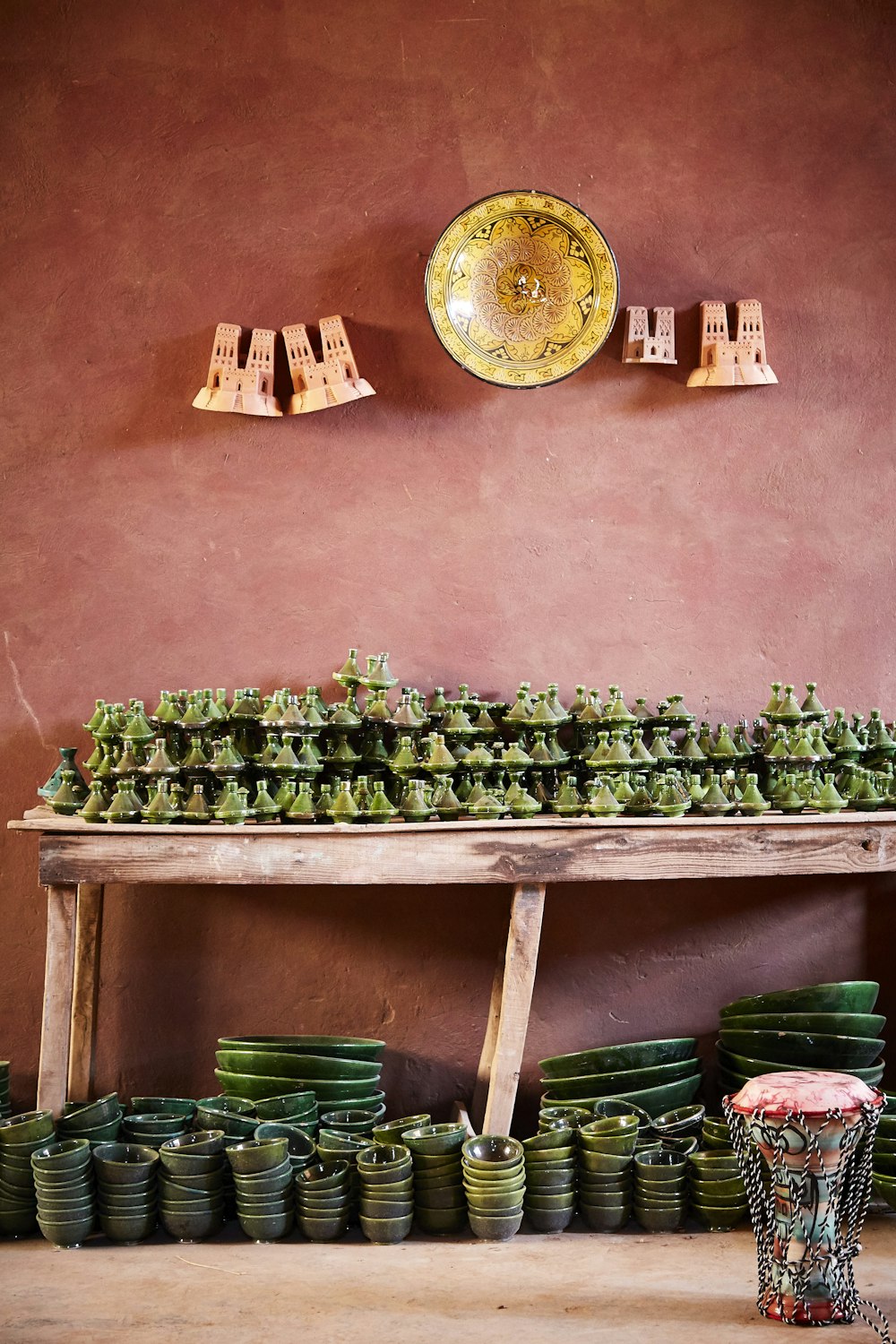 Lote de cuenco verde debajo de la mesa de madera