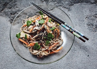 vegetable noodle with chopstick on glass plate